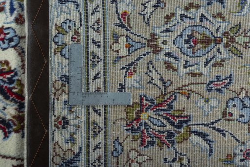 Backside of handmade 2000s Kashan rug showing knot structure and weave density