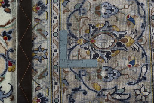 Backside of handmade 2000s Kashan rug showing knot structure and weave density