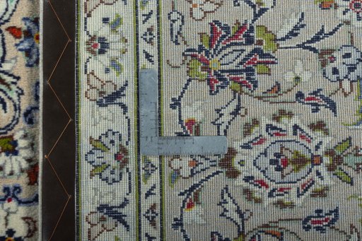 Backside of handmade 2000s Kashan rug showing knot structure and weave density