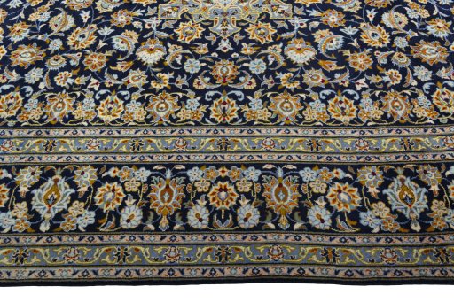 Corner detail of 2000s Kashan rug showing border pattern and Wool pile