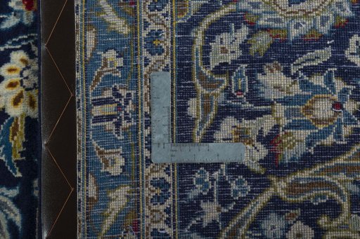 Backside of handmade 2000s Kashan rug showing knot structure and weave density