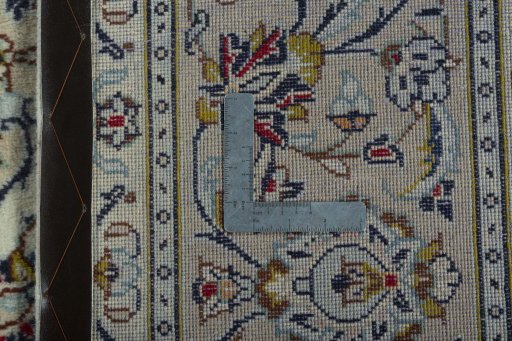 Backside of handmade 2000s Kashan rug showing knot structure and weave density