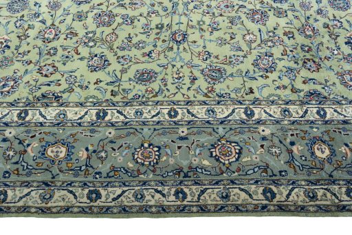 Corner detail of 2000s Kashan rug showing border pattern and Wool pile