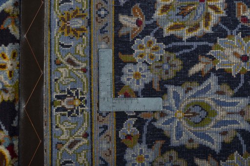 Backside of handmade 2000s Kashan rug showing knot structure and weave density