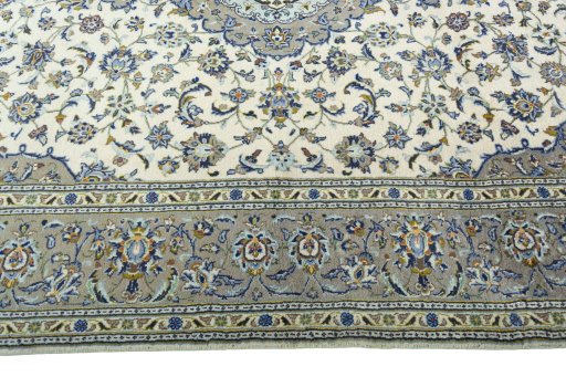 Corner detail of 2000s Kashan rug showing border pattern and Wool pile