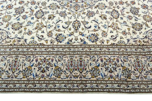 Corner detail of 2000s Kashan rug showing border pattern and Wool pile
