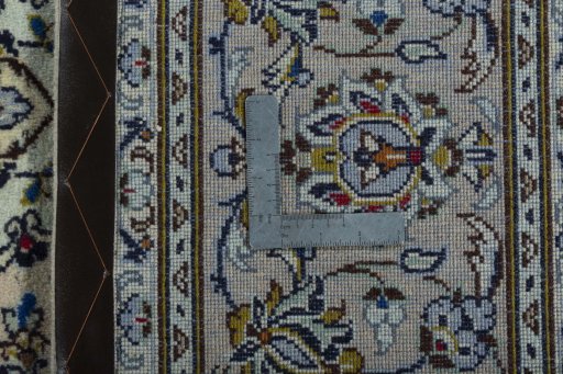 Backside of handmade 2000s Kashan rug showing knot structure and weave density