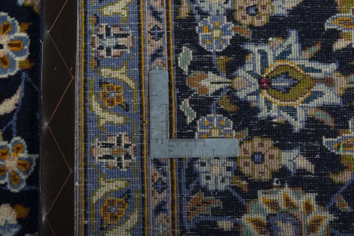 Backside of handmade 2000s Kashan rug showing knot structure and weave density
