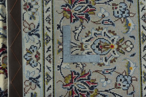 Backside of handmade 2000s Kashan rug showing knot structure and weave density