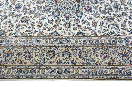 Corner detail of 2000s Kashan rug showing border pattern and Wool pile