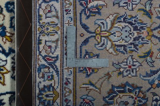 Backside of handmade 2000s Kashan rug showing knot structure and weave density