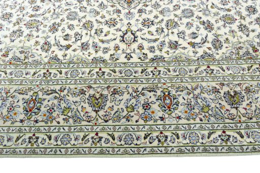 Corner detail of 2000s Kashan rug showing border pattern and Wool pile