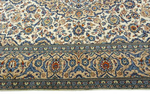 Corner detail of 2000s Kashan rug showing border pattern and Wool pile
