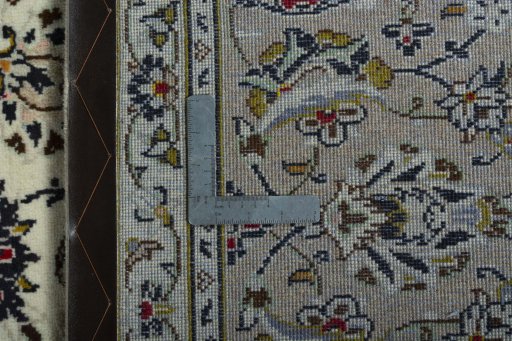 Backside of handmade 2000s Kashan rug showing knot structure and weave density