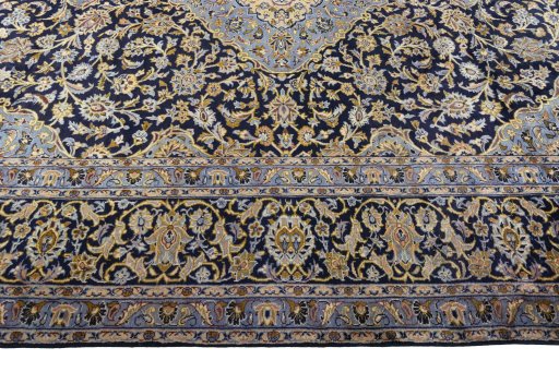 Corner detail of 2000s Kashan rug showing border pattern and Wool pile