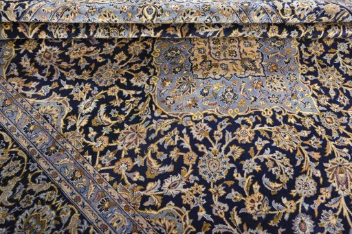 Close-up detail of 2000s Kashan rug from Iran / Persia showing Wool weave