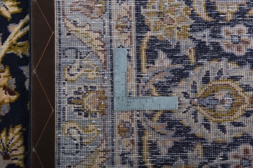 Backside of handmade 2000s Kashan rug showing knot structure and weave density