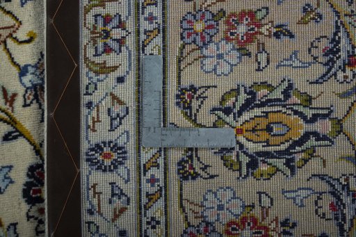 Backside of handmade 2000s Kashan rug showing knot structure and weave density