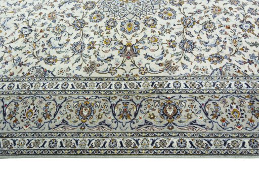 Corner detail of 2000s Kashan rug showing border pattern and Wool pile