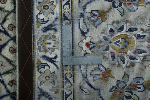 Backside of handmade 2000s Kashan rug showing knot structure and weave density