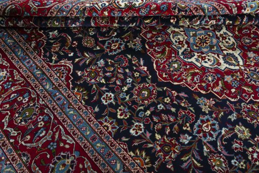Close-up detail of 2000s Kashan rug from Iran / Persia showing Wool weave
