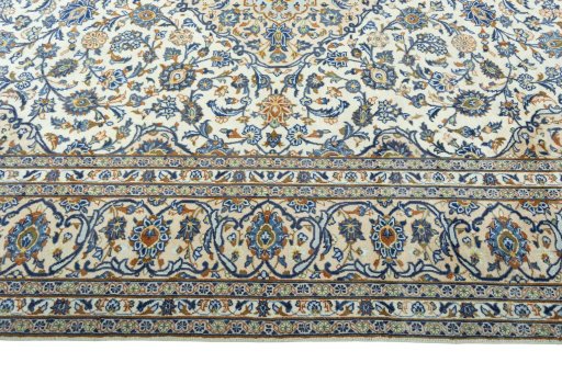 Corner detail of 2000s Kashan rug showing border pattern and Wool pile