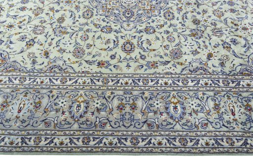 Corner detail of 2000s Kashan rug showing border pattern and Wool pile