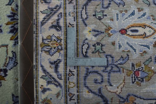 Backside of handmade 2000s Kashan rug showing knot structure and weave density