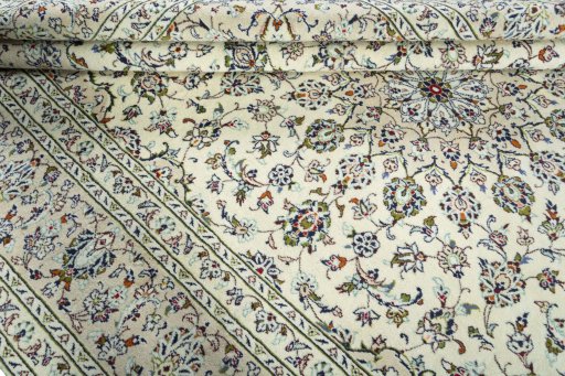 Corner detail of 2000s Kashan rug showing border pattern and Wool pile
