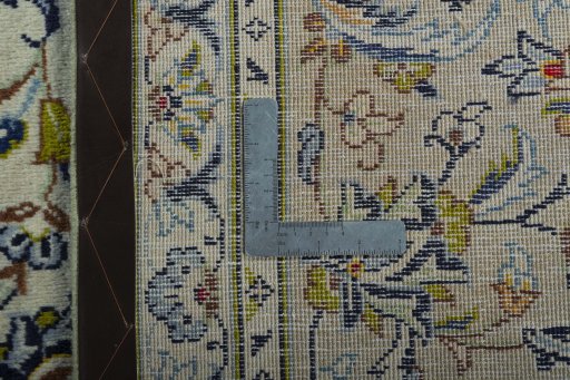 Backside of handmade 1970s Kashan rug showing knot structure and weave density