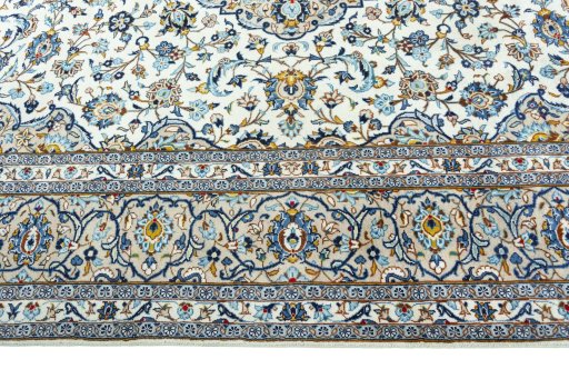 Corner detail of 2000s Kashan rug showing border pattern and Wool pile
