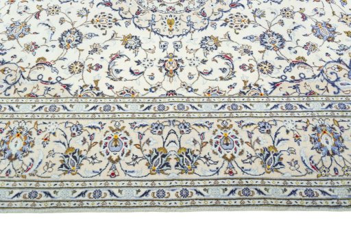 Corner detail of 2000s Kashan rug showing border pattern and Wool pile