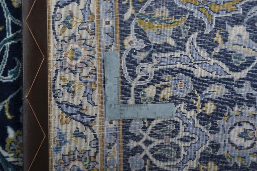 Backside of handmade 2000s Kashan rug showing knot structure and weave density