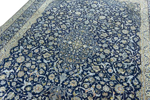 Backside of handmade 2000s Kashan rug showing knot structure and weave density
