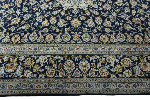 Corner detail of 2000s Kashan rug showing border pattern and Wool pile