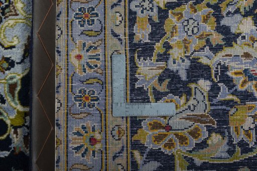 Backside of handmade 2000s Kashan rug showing knot structure and weave density