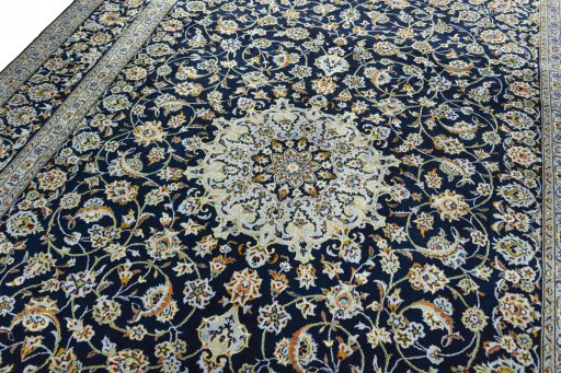 Backside of handmade 2000s Kashan rug showing knot structure and weave density