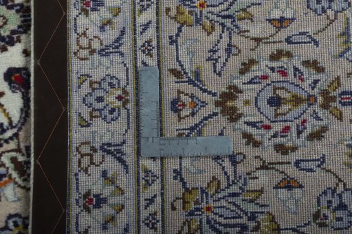 Backside of handmade 2000s Kashan rug showing knot structure and weave density