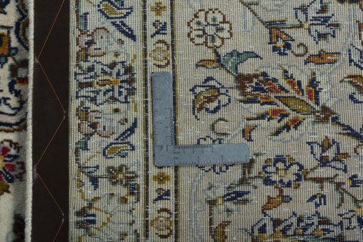 Backside of handmade 2000s Kashan rug showing knot structure and weave density