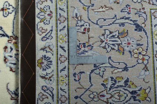 Backside of handmade 2000s Kashan rug showing knot structure and weave density