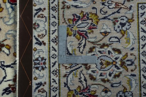 Backside of handmade 2000s Kashan rug showing knot structure and weave density