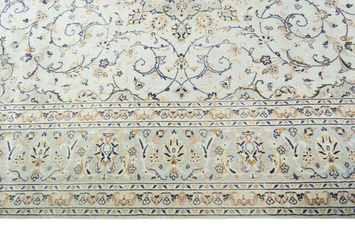 Corner detail of 2000s Kashan rug showing border pattern and Wool pile