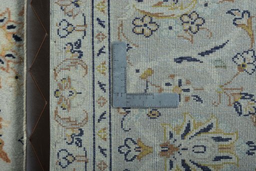 Backside of handmade 2000s Kashan rug showing knot structure and weave density