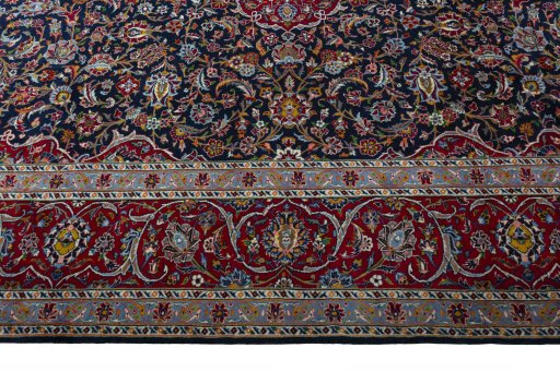 Corner detail of 2000s Kashan rug showing border pattern and Wool pile