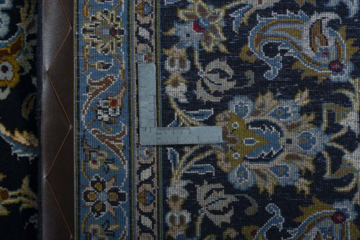 Backside of handmade 2000s Kashan rug showing knot structure and weave density