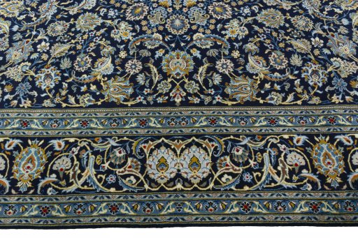 Corner detail of 2000s Kashan rug showing border pattern and Wool pile