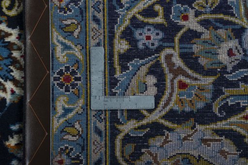 Backside of handmade 2000s Kashan rug showing knot structure and weave density