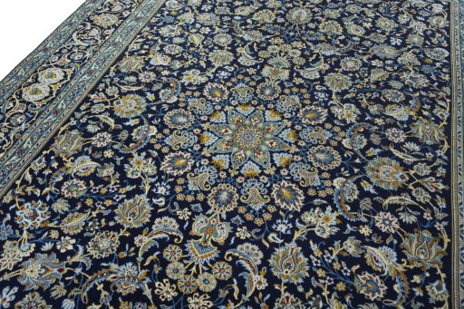 Backside of handmade 2000s Kashan rug showing knot structure and weave density