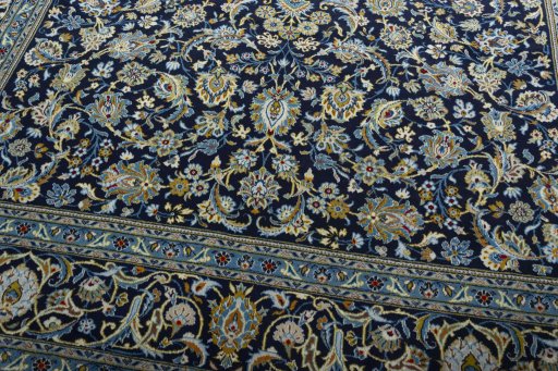 Close-up detail of 2000s Kashan rug from Iran / Persia showing Wool weave