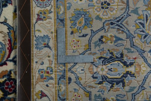 Backside of handmade 2000s Kashan rug showing knot structure and weave density